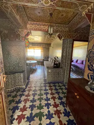 a room with a tile floor and a living room at Séjour cosy à Palm Beach Mansouriah in Pont Blondin