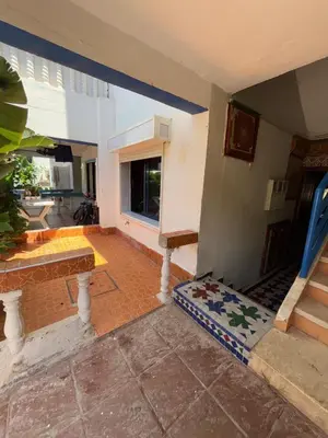 a living room with a couch and a window at Séjour cosy à Palm Beach Mansouriah in Pont Blondin