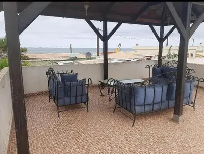 a group of chairs sitting under a gazebo at Villa plage david in Kasba Bou Hamira