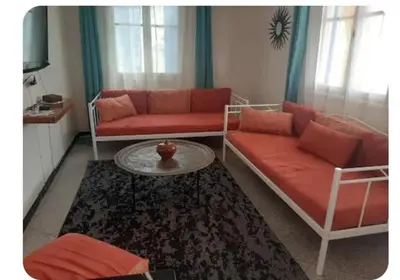 a living room with two couches and a table at Villa plage david in Kasba Bou Hamira