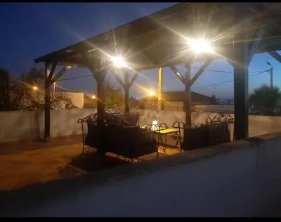 a gazebo with lights on it at night at Villa plage david in Kasba Bou Hamira