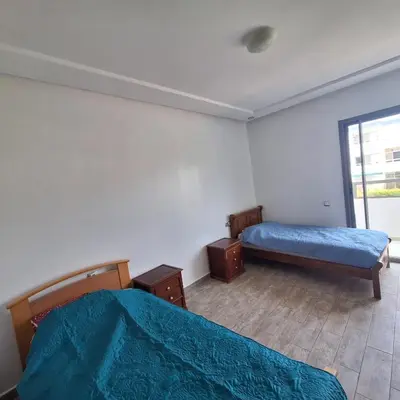 a bedroom with two beds and a window at Appartement à 10min de la mer in Mansouria