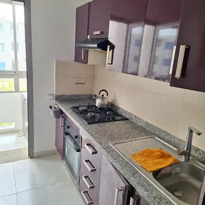 a kitchen with a sink and a stove at Appartement à 10min de la mer in Mansouria