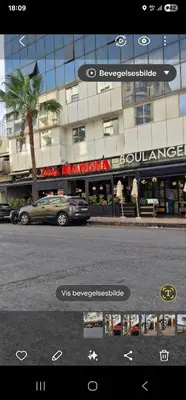 a car parked in front of a building at 2Roms 5mn Palmier Maarif Distriktet Wifi Rapide A4 in Casablanca