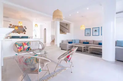 a living room with two chairs and a table at Villa in Golf Resort with Shared Pool in Bouznika