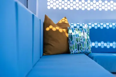 a blue couch with a pillow on top of it at Villa in Golf Resort with Shared Pool in Bouznika