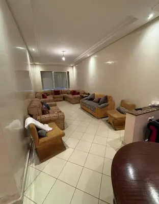 a living room with couches and chairs in a room at Appartement sidi rehal l'ocean in Sidi Rahal