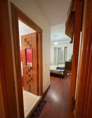 a hallway with a door to a room with a bedroom at Appartement sidi rehal l'ocean in Sidi Rahal