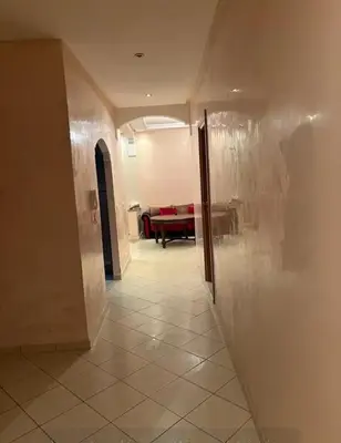 a hallway with a room with a couch in the background at Appartement sidi rehal l'ocean in Sidi Rahal