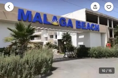 a building with a sign on the side of it at Appartement dans une résidence fermée, Malaga Beach in Mohammedia
