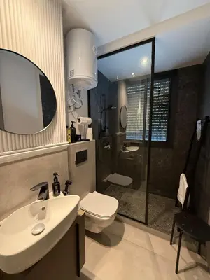 a bathroom with a sink and a toilet and a shower at Central Luxury Apartment with Fast Fiber WiFi, Terrace & Free Parking in Casablanca Close To KFC MCDO & School Group La Résidence Boulevard 2 Mars in Casablanca