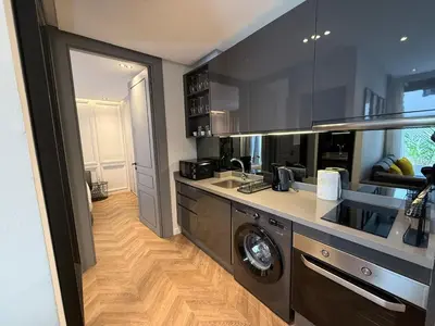 a kitchen with a washer and a washing machine in it at Central Luxury Apartment with Fast Fiber WiFi, Terrace & Free Parking in Casablanca Close To KFC MCDO & School Group La Résidence Boulevard 2 Mars in Casablanca