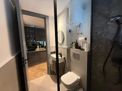 a bathroom with a toilet and a sink and a mirror at Central Luxury Apartment with Fast Fiber WiFi, Terrace & Free Parking in Casablanca Close To KFC MCDO & School Group La Résidence Boulevard 2 Mars in Casablanca