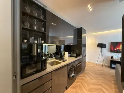 a kitchen with a sink and a washing machine at Central Luxury Apartment with Fast Fiber WiFi, Terrace & Free Parking in Casablanca Close To KFC MCDO & School Group La Résidence Boulevard 2 Mars in Casablanca