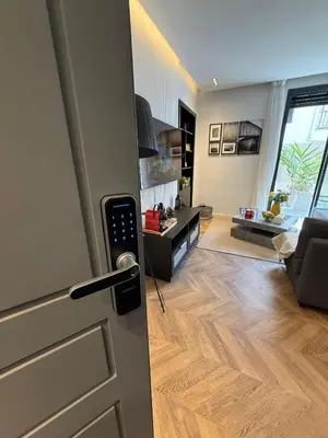 a door leading into a living room with a kitchen at Central Luxury Apartment with Fast Fiber WiFi, Terrace & Free Parking in Casablanca Close To KFC MCDO & School Group La Résidence Boulevard 2 Mars in Casablanca