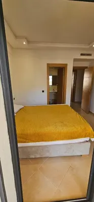 a bedroom with a large yellow bed in a room at El Mansouria Mohammedia Casablanca in Pont Blondin