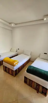 two beds sitting in a room with at El Mansouria Mohammedia Casablanca in Pont Blondin