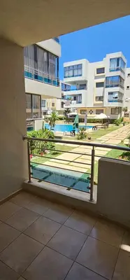 a balcony with a view of a pool and buildings at El Mansouria Mohammedia Casablanca in Pont Blondin