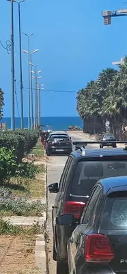 a line of cars parked on the side of a road at El Mansouria Mohammedia Casablanca in Pont Blondin