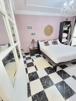 a bedroom with a bed and a checkered floor at Spacious and convenient in Casablanca