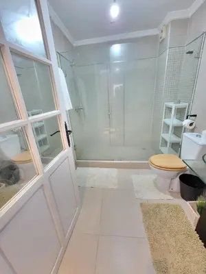 a bathroom with a toilet and a glass shower at Spacious and convenient in Casablanca