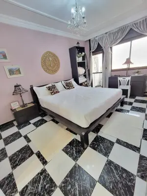 a bedroom with a large bed and a checkered floor at Spacious and convenient in Casablanca