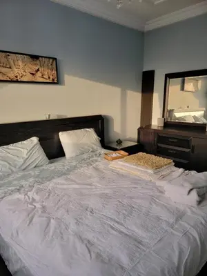 a bedroom with a large white bed and a mirror at Spacious and convenient in Casablanca