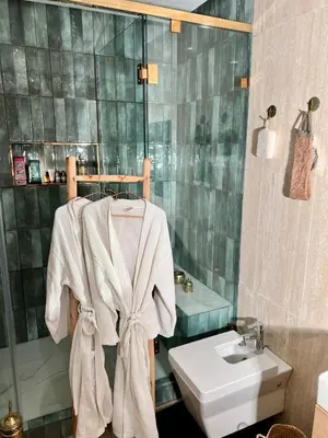 a bathroom with a sink and a towel at Logement 5 etoiles avec piscine et jardin privée à rabat hay riad in Rabat