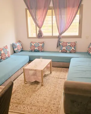 a living room with blue couches and a coffee table at Perfect Family Apartment in Tamaris