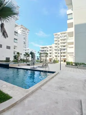 a swimming pool in front of a building at Studio Cosy avec Mezzanine Piscine et Plage à 5 min à Zenata City in Aïn Harrouda