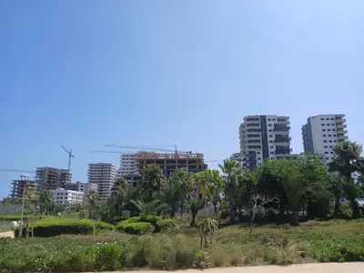 a city skyline with palm trees and buildings at Studio Cosy avec Mezzanine Piscine et Plage à 5 min à Zenata City in Aïn Harrouda