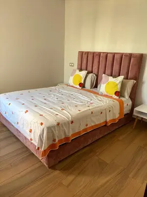 a bedroom with a large bed with yellow pillows at Appartement vue piscine - Pour Famille - Blue Beach SIDI RAHAL in Sidi Rahal
