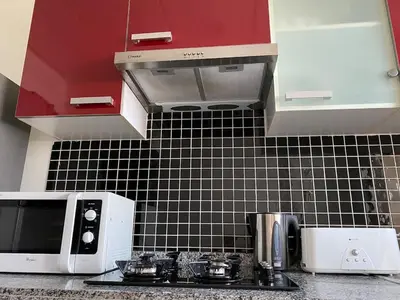 a kitchen with a microwave and a counter top at Appartement deux chambre confortable près de la Gare - Restau - cafes - Plage in Casablanca