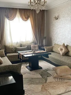 a living room with a couch and a table at Appartement deux chambre confortable près de la Gare - Restau - cafes - Plage in Casablanca