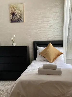 a bed with a black headboard and two pillows at Appartement deux chambre confortable près de la Gare - Restau - cafes - Plage in Casablanca
