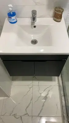 a white sink in a bathroom with marble floors at Appartement deux chambre confortable près de la Gare - Restau - cafes - Plage in Casablanca
