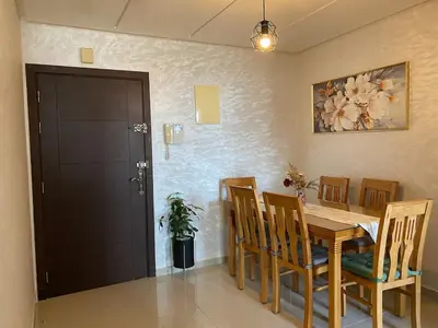 a dining room with a wooden table and chairs at Appartement deux chambre confortable près de la Gare - Restau - cafes - Plage in Casablanca