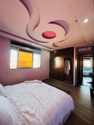 a bedroom with a large bed in a room with a ceiling at Rabat sidi yahya zaër in Sidi Yahia az Zaʼer