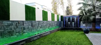 a garden with a wall with green and white at Rabat sidi yahya zaër in Sidi Yahia az Zaʼer