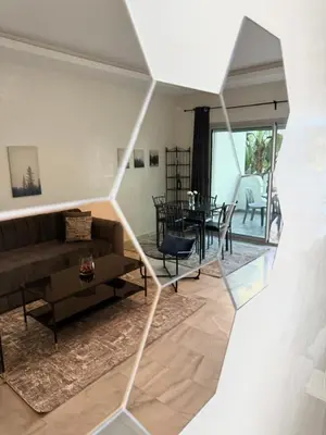 a living room with a couch and a table at Charmant Appart 5 minutes de La Plage Sablette in Mohammedia