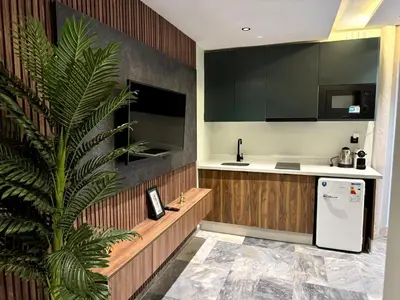 a kitchen with a white refrigerator and a palm tree at Studio casablanca connect in Casablanca