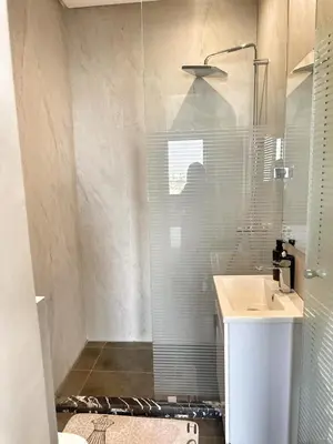 a glass shower in a bathroom with a sink at Ocean Dream in Casablanca