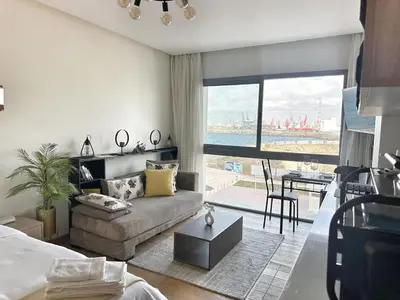 a living room with a couch and a large window at Ocean Dream in Casablanca