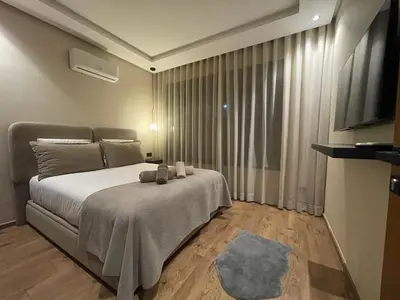 a bedroom with a bed and a large window at A 1 pas de Zara Magnifique Studio Premium in Casablanca