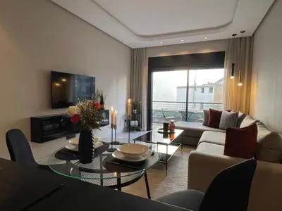 a living room with a couch and a table with candles at A 1 pas de Zara Magnifique Studio Premium in Casablanca