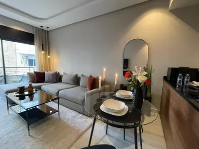 a living room with a couch and a table at A 1 pas de Zara Magnifique Studio Premium in Casablanca