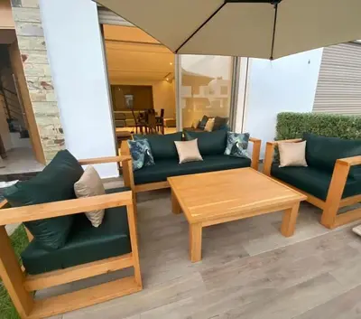 a living room with couches and a table and an umbrella at Luxury family villa in Casablanca