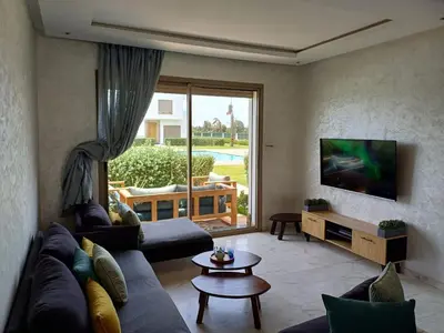 a living room with a couch and a tv at Luxury family villa in Casablanca