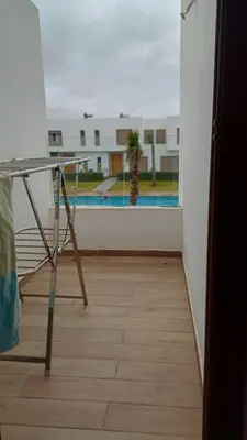 a room with a table and a view of a pool at Luxury family villa in Casablanca