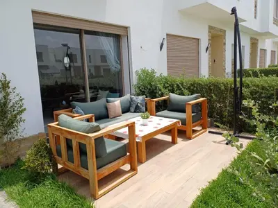 a patio with two chairs and a table at Luxury family villa in Casablanca